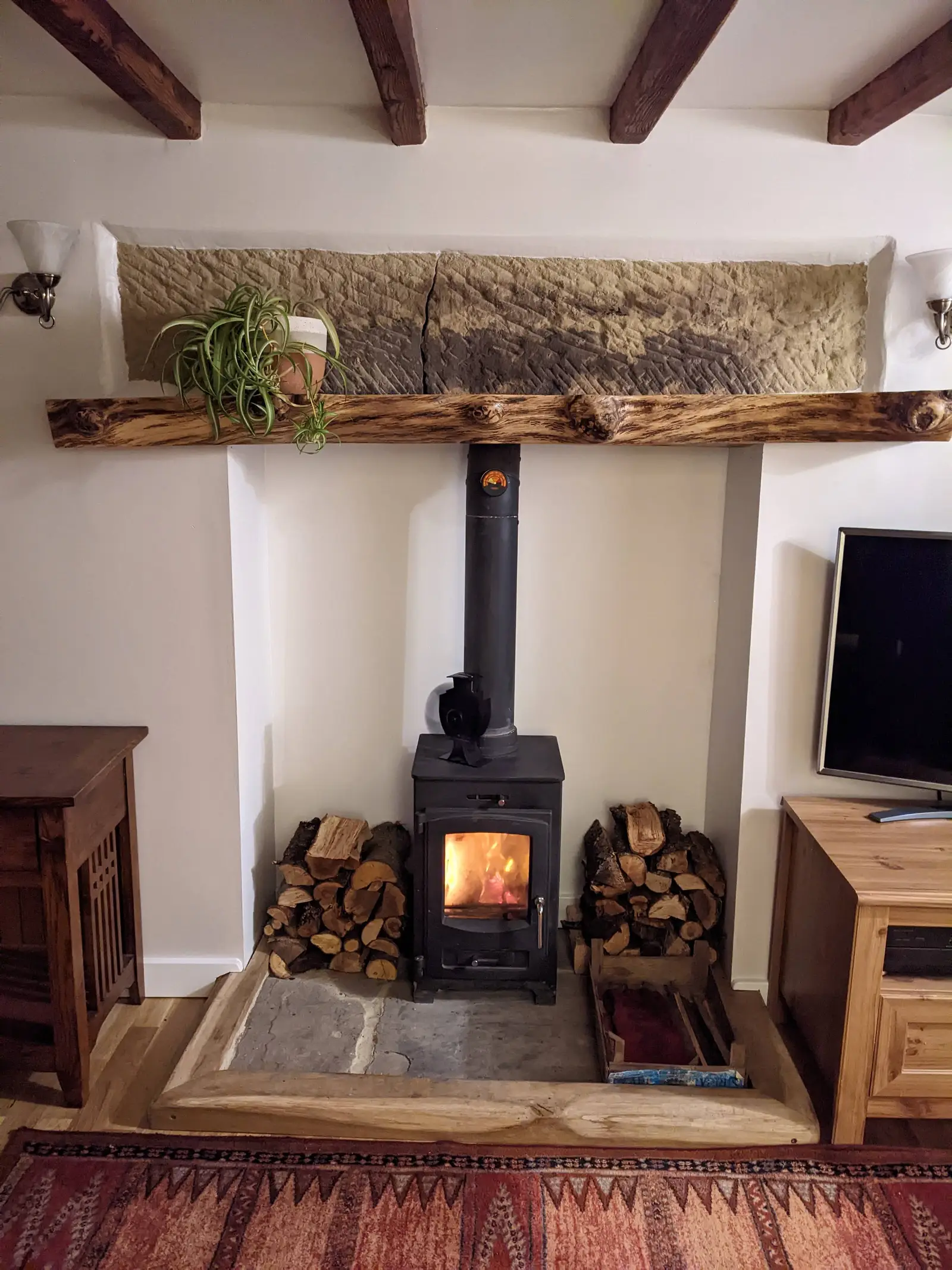 A bespoke oak mantle shelf installation